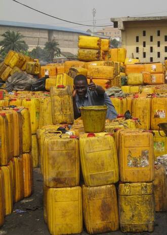 Oil jug salesman giving a thumbs up, Kumasi, Guinea