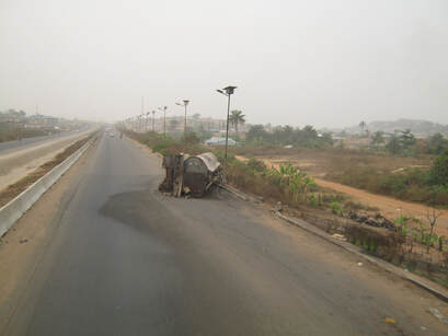 Frequent highway occurrence, oil tanker spilled on the side of the road left to rust, Nigeria