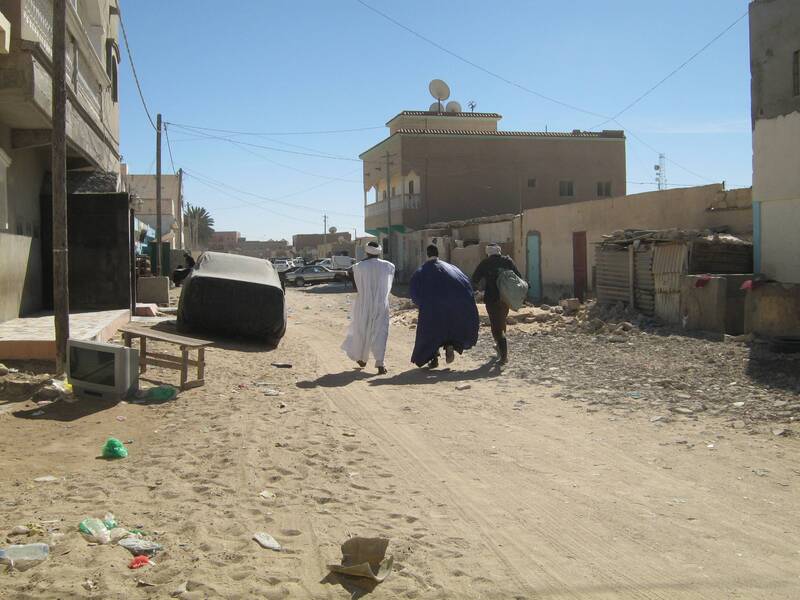 Men walking down a street in Nouadhibou