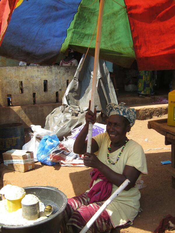 A woman with her pretty umbrella, Guinean market