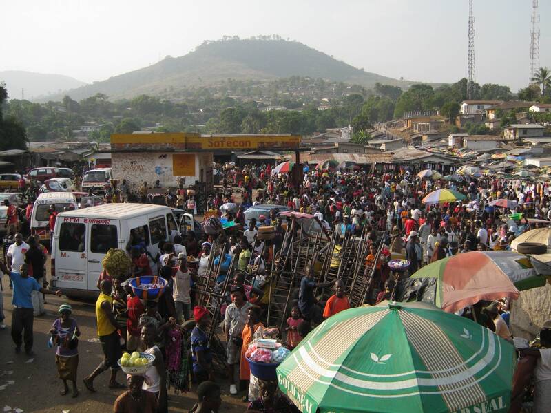 Large crowd with "Lion Mountain" in the distance, Sierra Leone